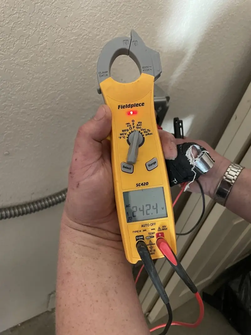 Voltage testing with clamp meter during Electrical Installation Services in Fort Atkinson